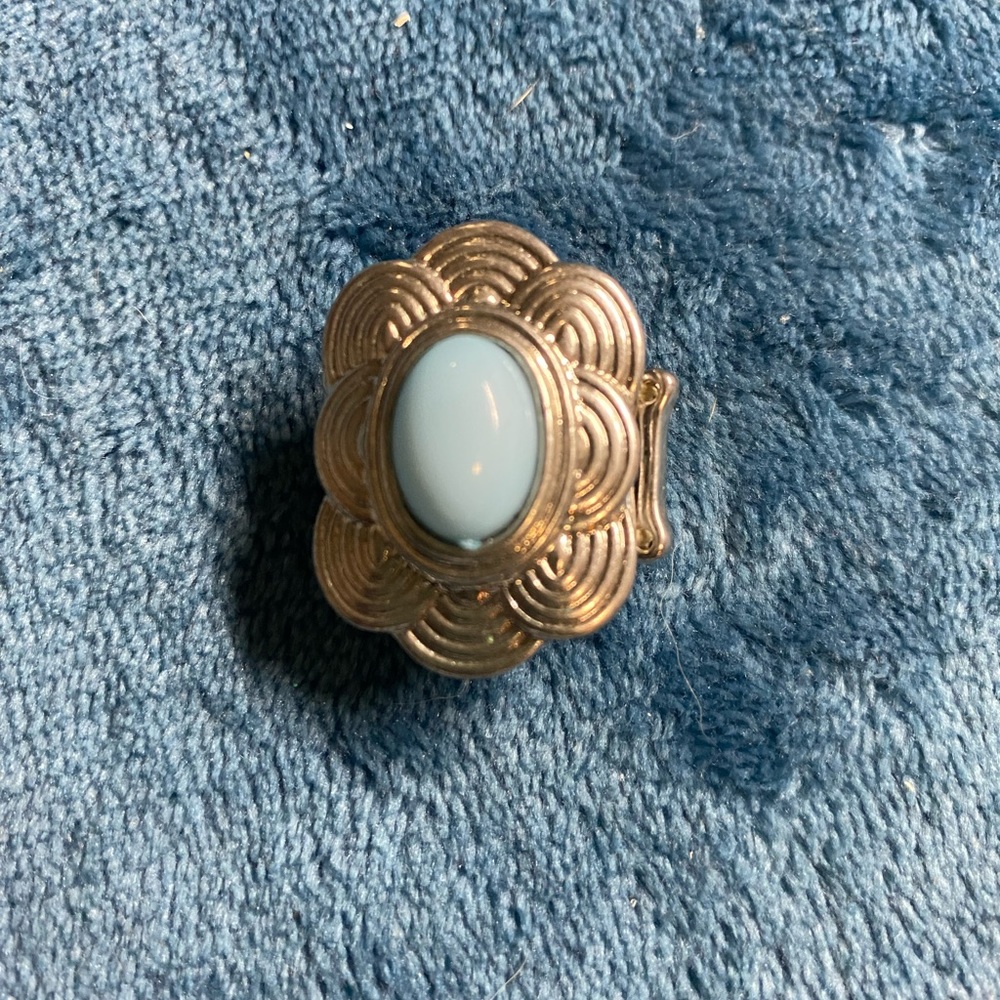 Silver stretchy ring with blue stone.